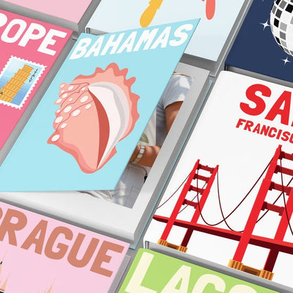 Close-up of a personalized travel photo book for the Bahamas, surrounded by other custom destination albums like San Francisco and Prague.