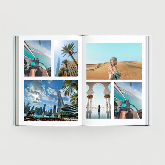 Open custom travel photo book displaying high-quality printed vacation memories from Dubai, featuring desert landscapes and cityscapes.